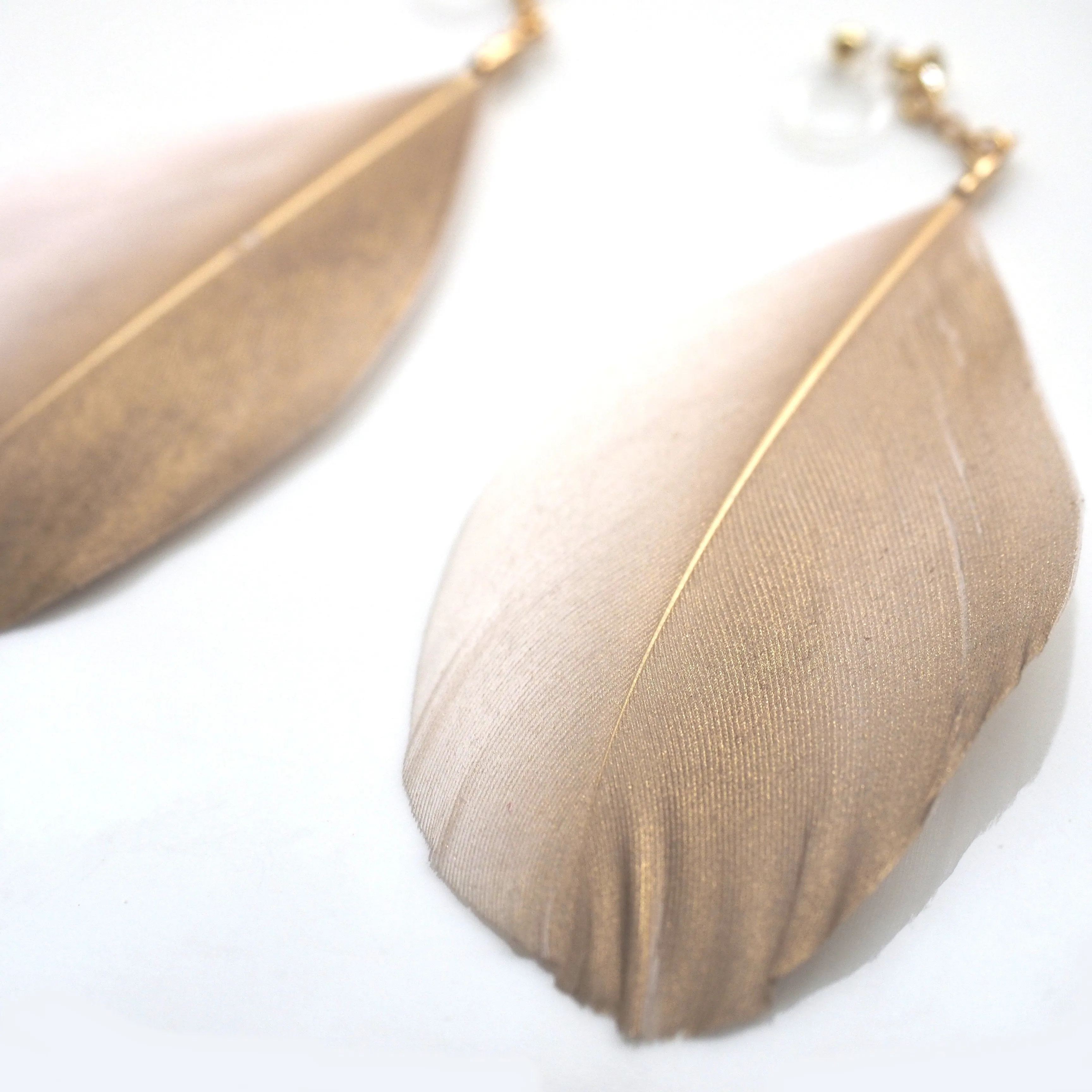 Gold painted pink feather invisible clip on earrings